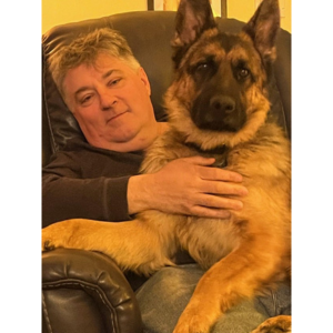 Bill with his large German Shepard on his lap