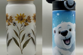 A frosted white cup with painted on sunflowers and a metal water bottle that is blue with a white polar bear