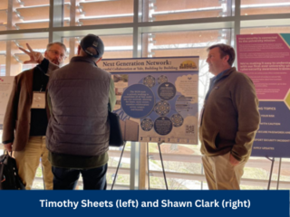 Timothy Sheets and Shawn Clark discussing NGN with an attendee.