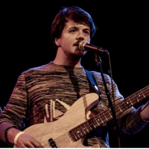 Kevin O'Donnell playing the guitar on a stage