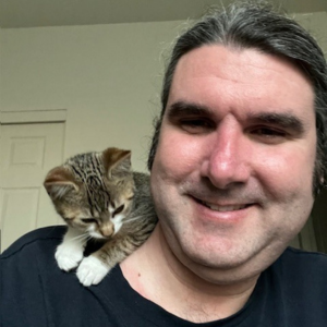 David with his black and tan striped kitten sitting on his shoulder
