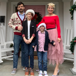 Gina with her other partner, Alex, and 2 children, Miles and Dylan in front of their home