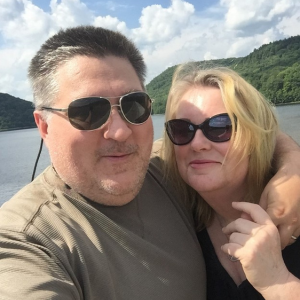 Bill and Ali in front of a lake and mountains